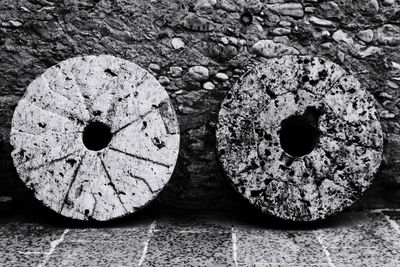 Old stone wheels against wall