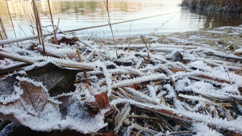 Close-up of frozen water on snow covered landscape