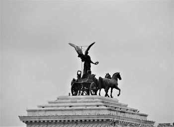 Low angle view of statue against sky