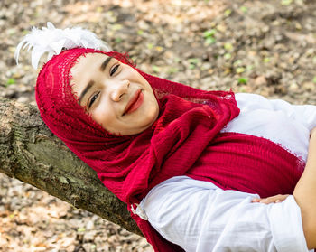 Portrait of smiling girl lying on snow