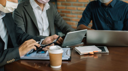 Midsection of business colleagues working at office