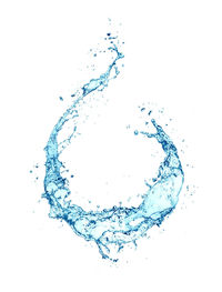 Close-up of water drops on glass against white background