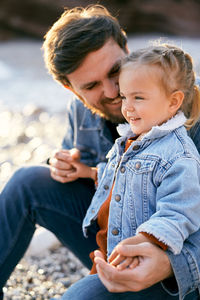 Mother and daughter sitting outdoors