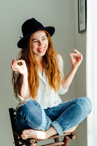 Portrait of smiling young woman using mobile phone