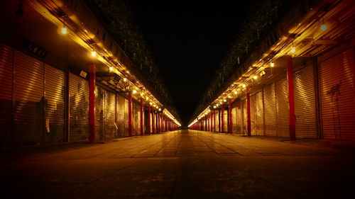 Empty illuminated corridor at night