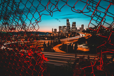 High angle view of light trails on city at dusk