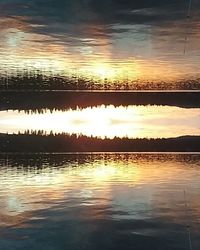 Reflection of clouds in sea at sunset