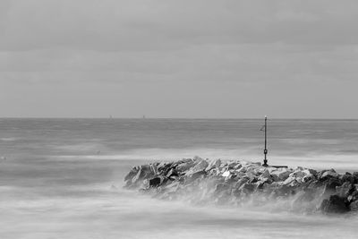 Scenic view of sea against cloudy sky