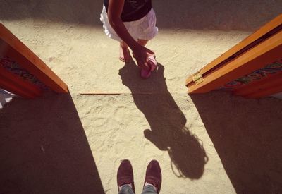 High angle view of girl standing at doorway in sand