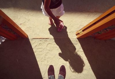 Low section of woman standing on tiled floor