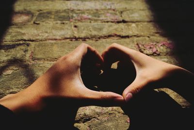 Low section of man with heart shape against water