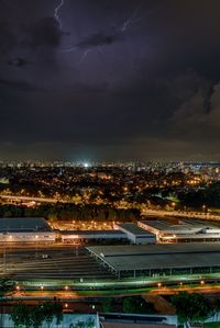 Illuminated cityscape against sky at night