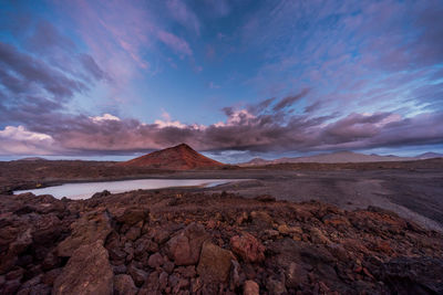 View of desert against cloudy sky