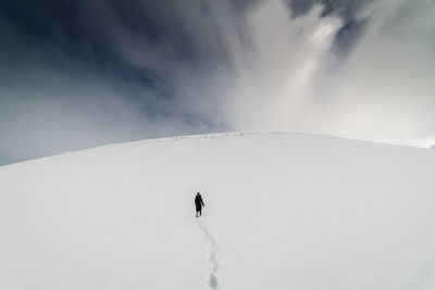 Low angle view of mountain against cloudy sky