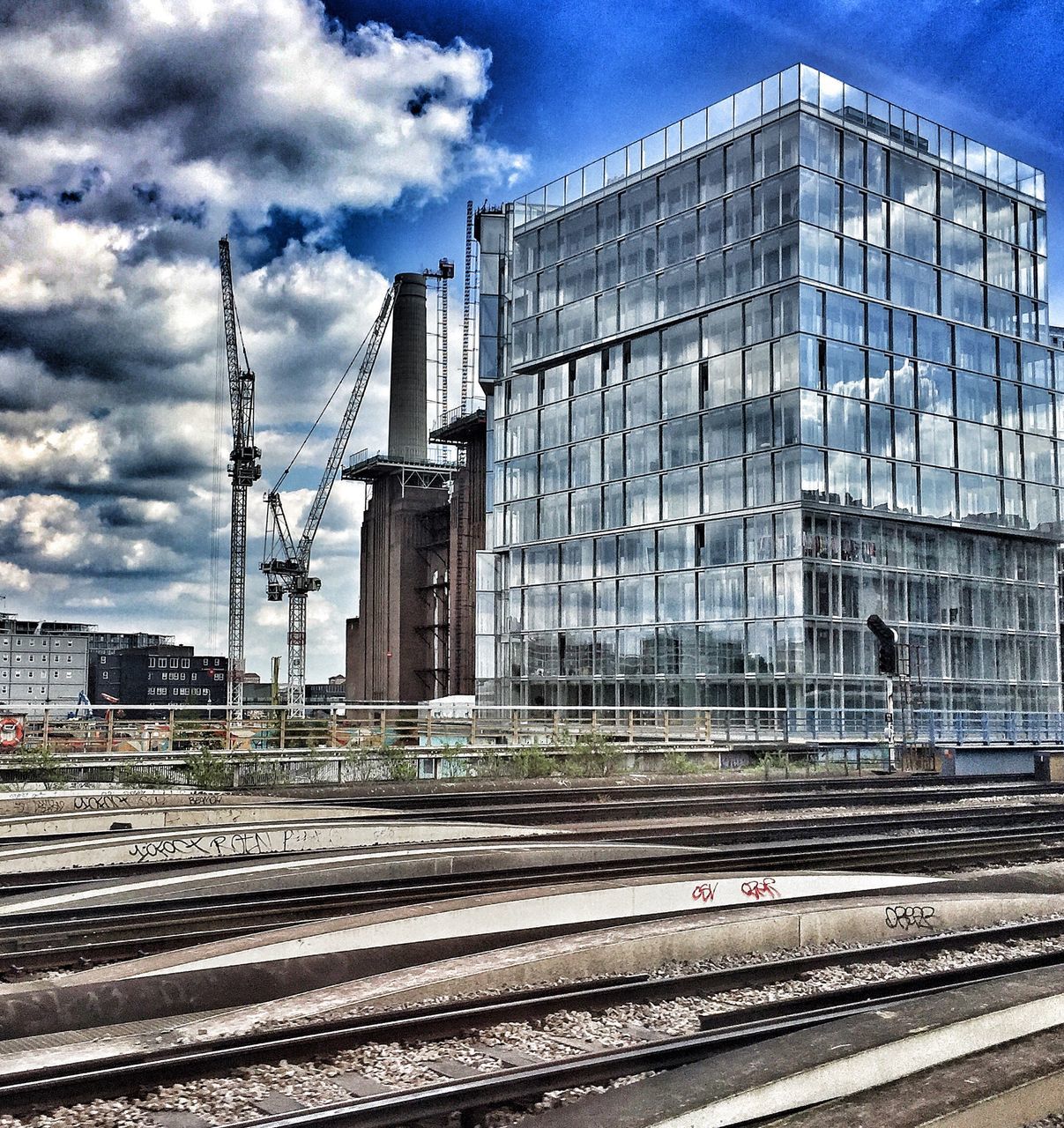 sky, architecture, cloud - sky, built structure, building exterior, railroad track, rail transportation, no people, industry, day, outdoors, modern, city