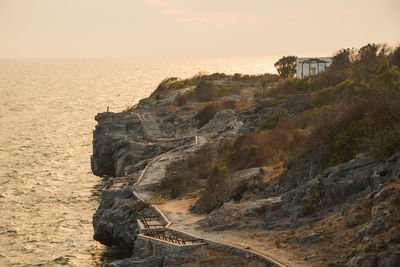 Scenic view of rock formation by sea against sky