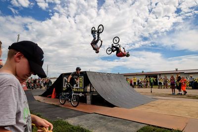 People skateboarding on skateboard against sky