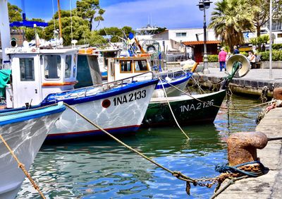 Fishing boats moored at harbor