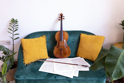 Close-up of papers on table against wall at home