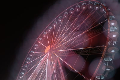 Low angle view of illuminated ferris wheel