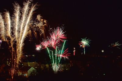 Low angle view of firework display at night