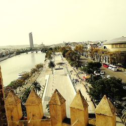 High angle view of buildings by street against clear sky