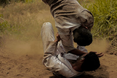 Teenage boys doing martial arts on field
