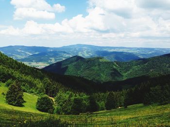 Scenic view of mountains against cloudy sky