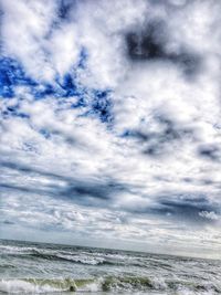 Scenic view of sea against cloudy sky