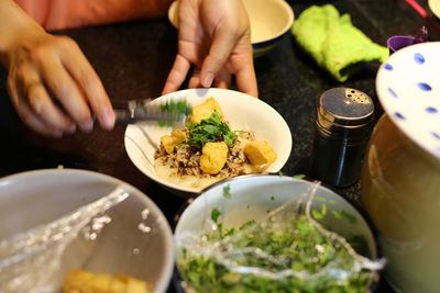 Cropped hand preparing food in kitchen