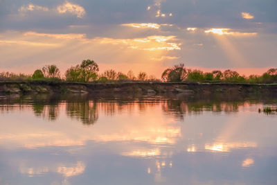 Scenic view of lake against sky during sunset