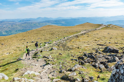 Couple of young hikers descending from ben lawers