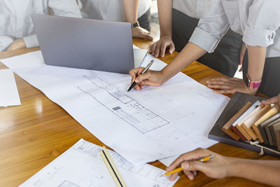 High angle view of people working on table