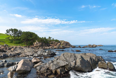 Rocks on beach against sky