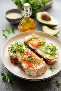 Sandwiches with salted salmon, avocado and microgreens. healthy food.