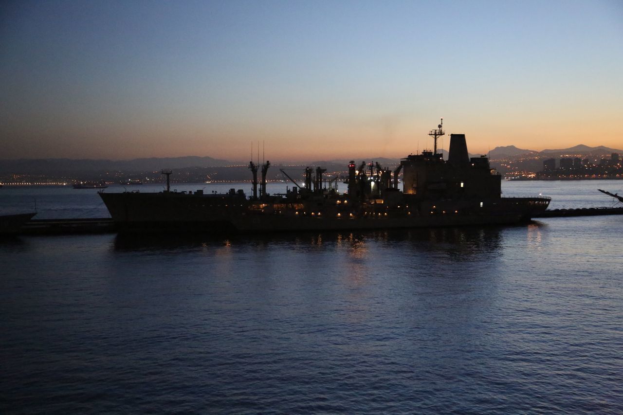 SILHOUETTE SHIP IN SEA AGAINST SKY AT SUNSET