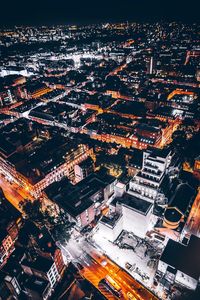 Aerial view of city lit up at night