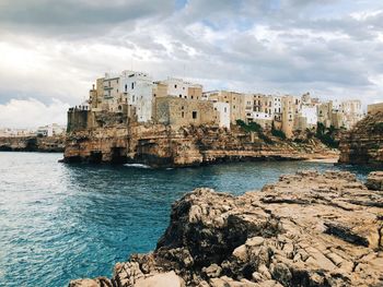 Panoramic view of sea and buildings against sky