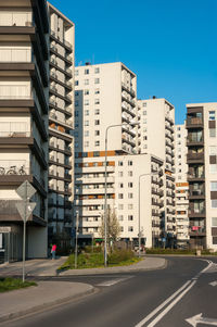 Buildings in city against clear sky