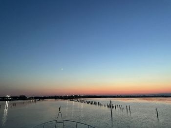 Scenic view of sea against clear sky during sunset