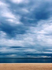 Scenic view of sea against storm clouds
