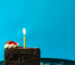 Close-up of cake on table against blue sky