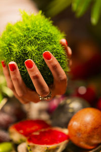 Close-up of hand holding strawberry