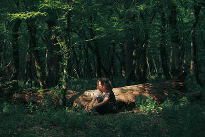 Woman sitting in a forest