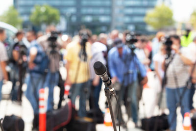 Close-up of microphone against people