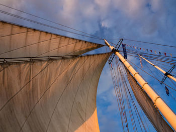 Low angle view of ship against cloudy sky