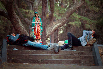 Woman sitting on tree stump