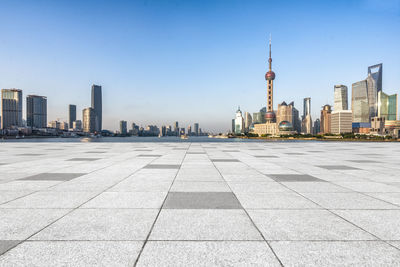 View of city buildings against clear sky