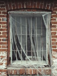 Close-up of window on brick wall