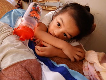 Portrait of cute baby lying on sofa at home